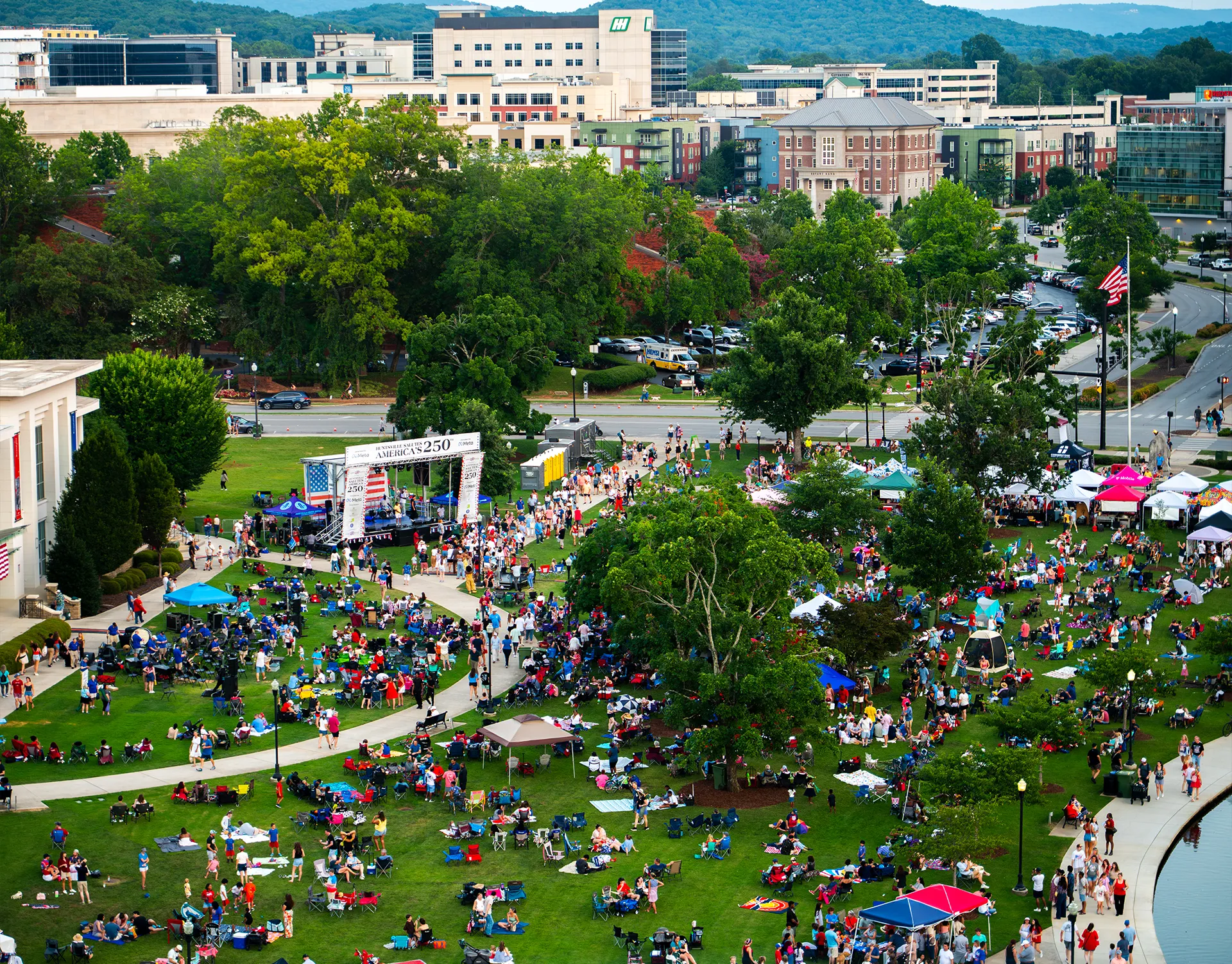 Aerial view of Huntsville Celebrates America's 250th in Big Spring Park with crowds gathered around the outdoor live event stage.