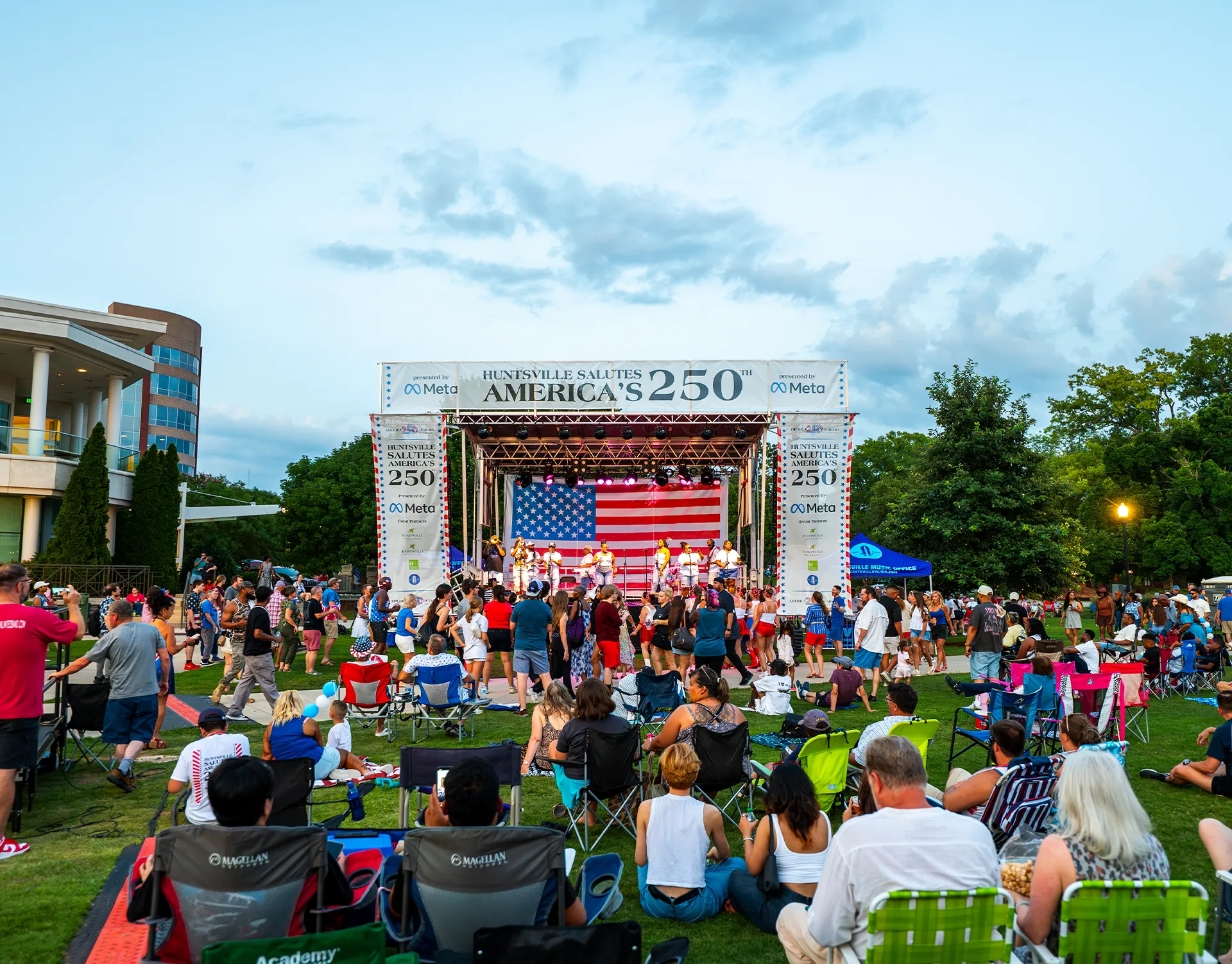 Crowd watching a live event performance at Huntsville Celebrates America's 250th in Big Spring Park.