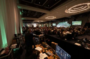 Bluewood Production audio engineer running live sound mixing console at a gala event.